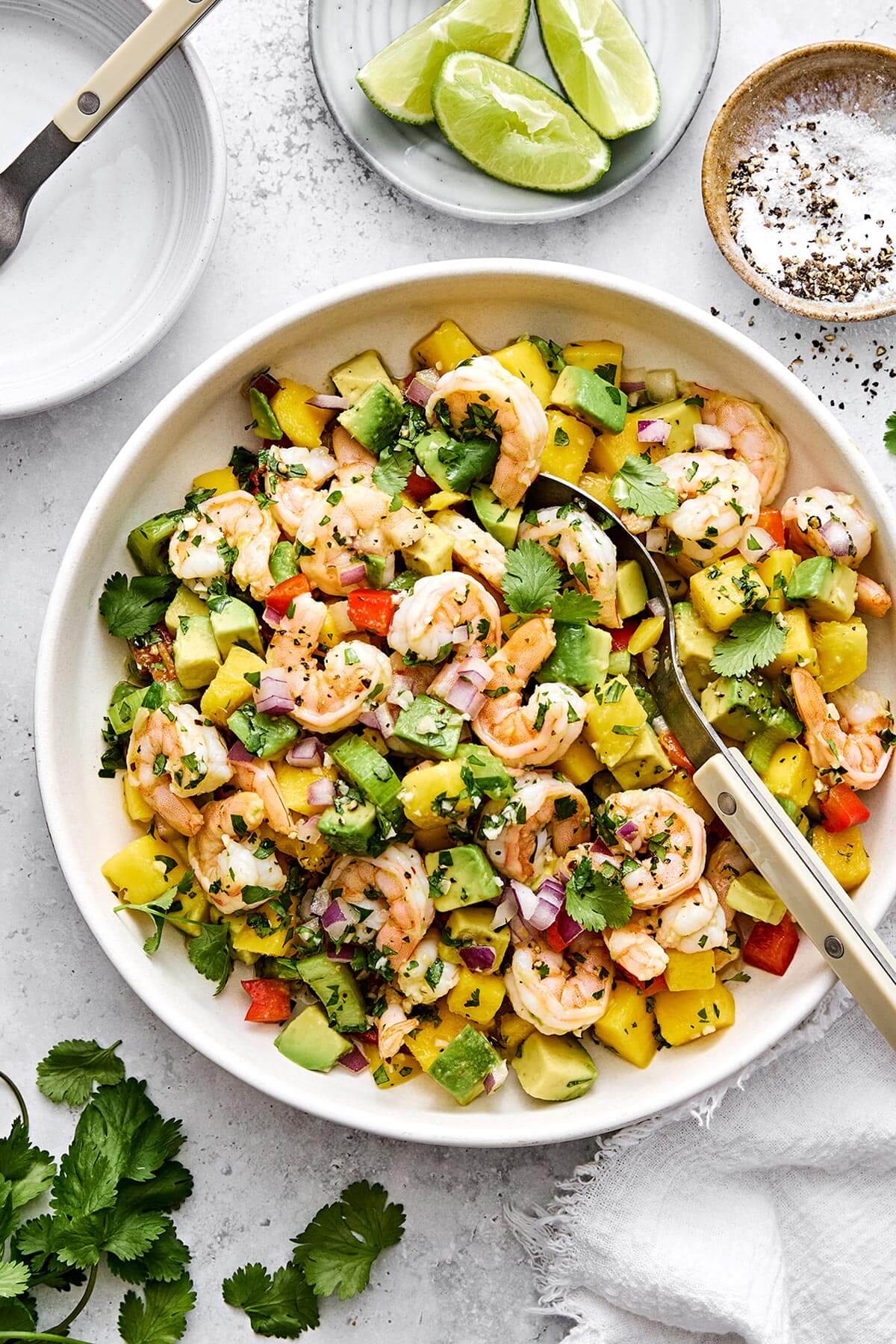 This mango avocado shrimp salad is sweet, crunchy, and tossed in a fresh honey lime dressing. It's the ultimate refreshing summer salad! A bowl of mango avocado shrimp salad.
