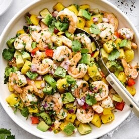 A bowl of mango avocado shrimp salad for summer.