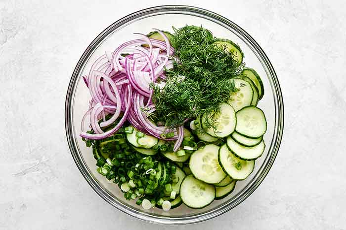 Ingredients for cucumber salad in a bowl.