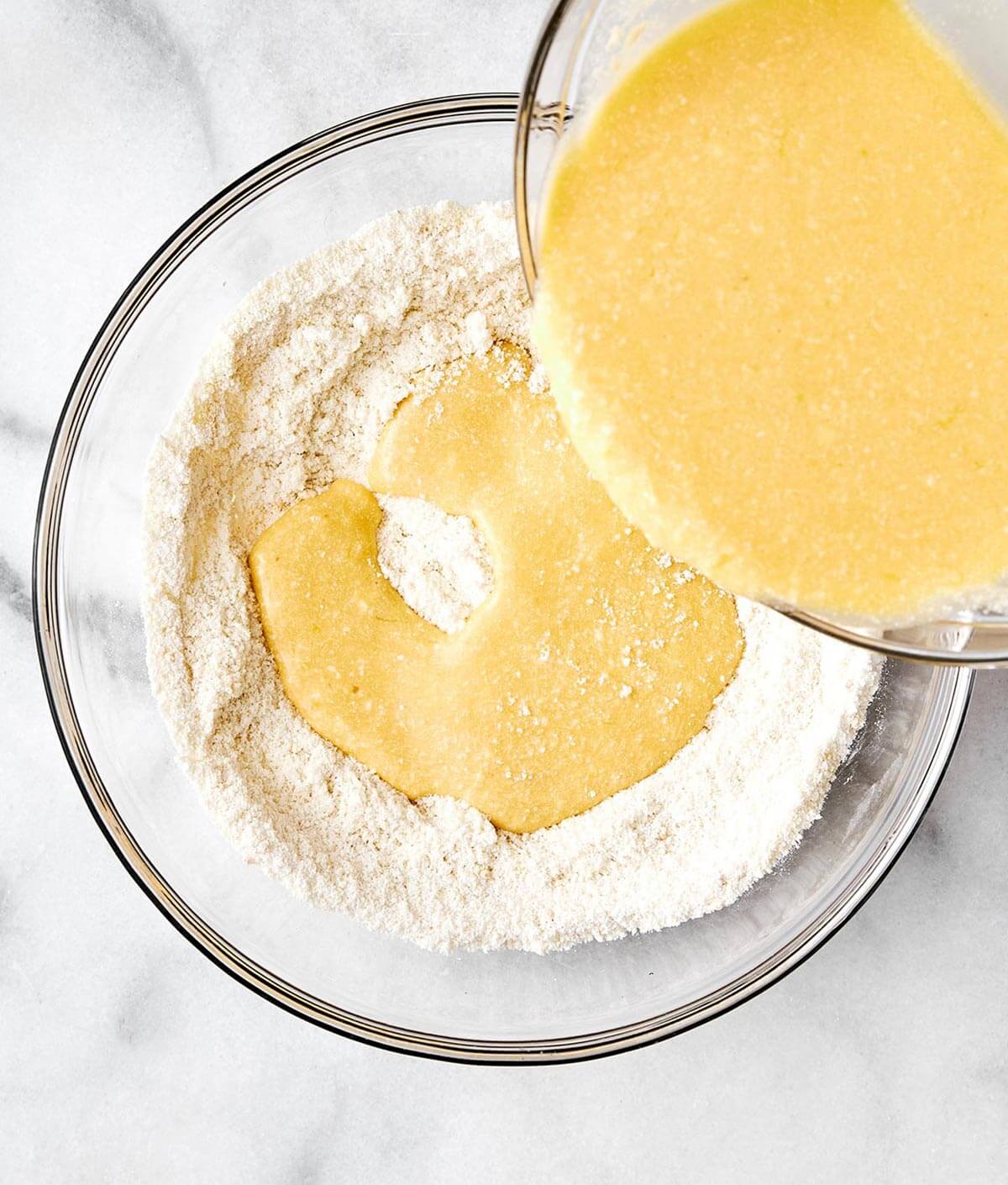 Mixing wet and dry protein pancake ingredients.