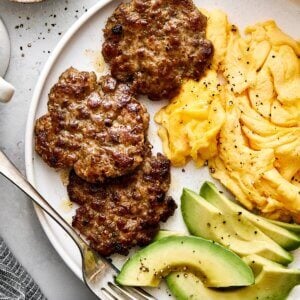 Breakfast plate of breakfast sausages and eggs.
