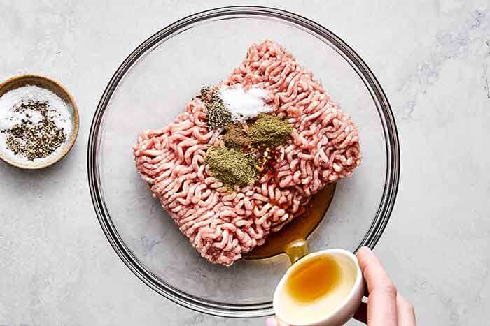 Mixing breakfast sausage patties.