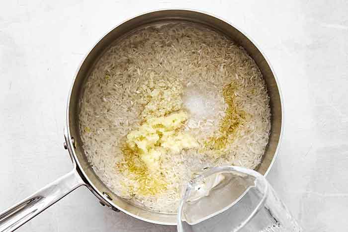 Cooking ginger rice in pot.