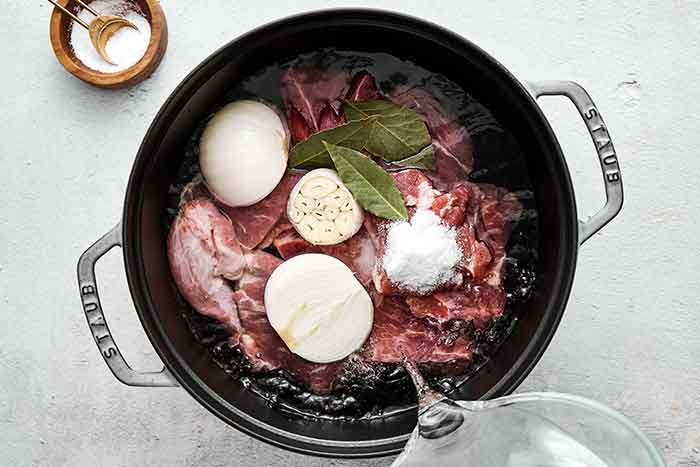 Cooking pork in a pot.