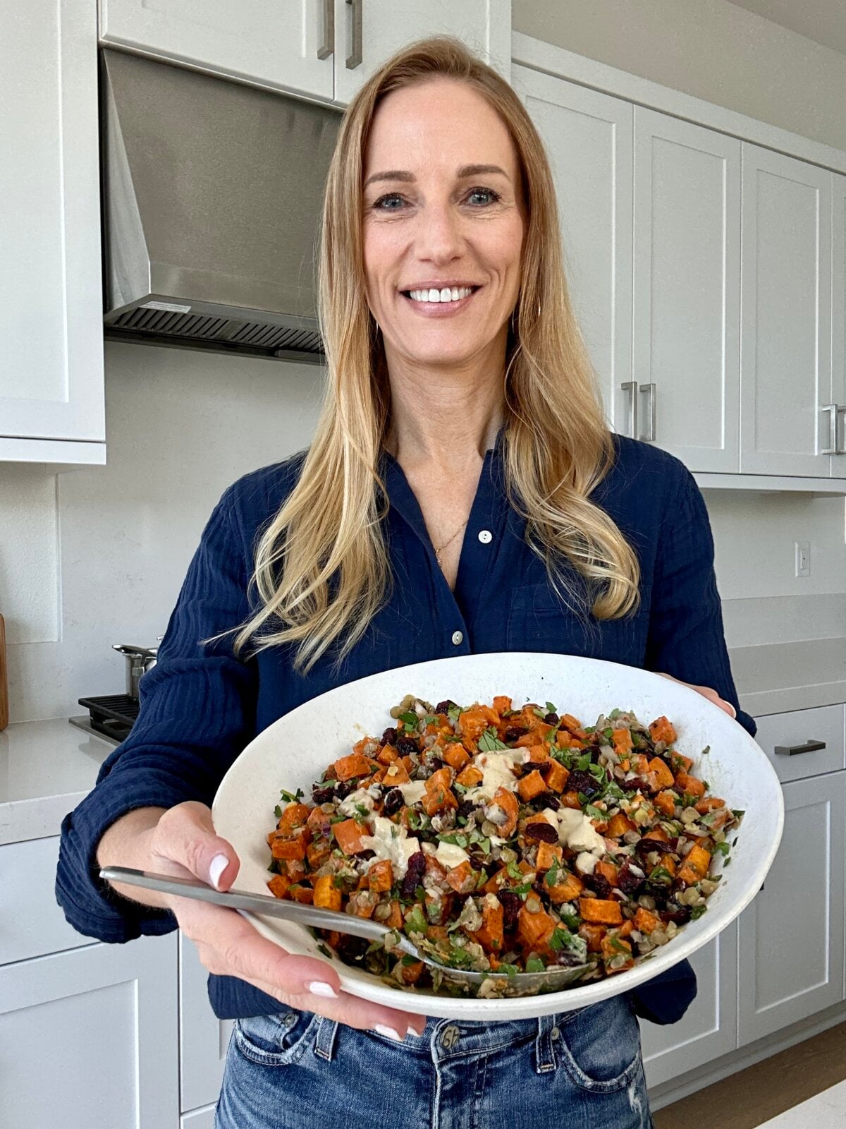 Lisa testing the sweet potato salad recipe in her kitchen.