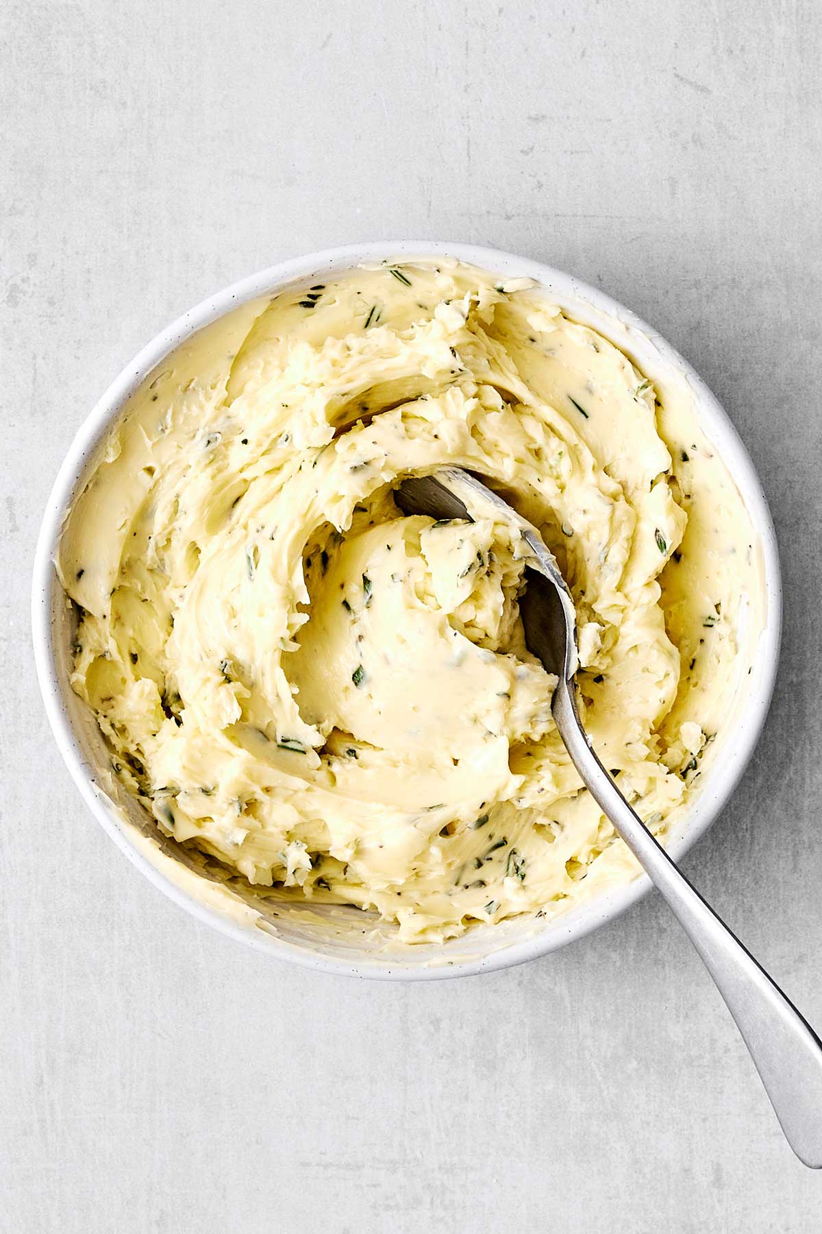 A bowl of herb butter spread.