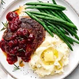 Balsamic cranberry ribeye steak with Christmas sides.
