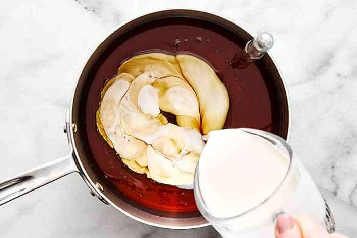 Step one of pecan pralines: Mix maple syrup and heavy cream.