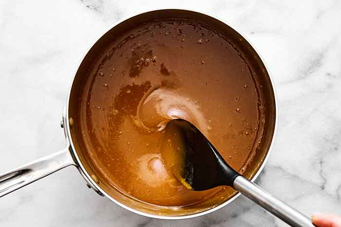 Step four of pecan pralines: Continue stirring.