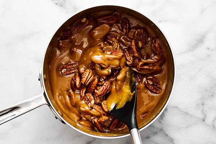 Step five of pecan pralines: Add pecans.