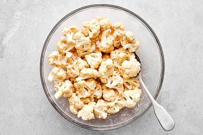 Step one of buffalo cauliflower: season the cauliflower.