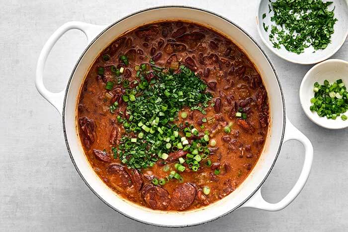 Step five of red beans and rice: Add green onion.