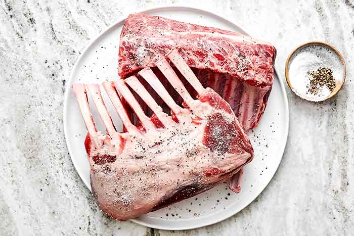 Step one of rack of lamb: season the lamb.