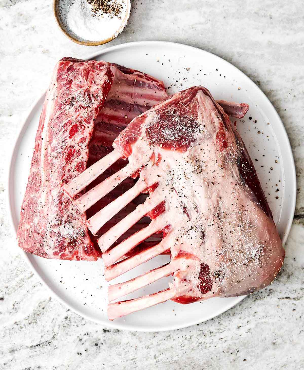 This rack of lamb with a Dijon herb crust will certainly shine at any holiday dinner. Plus, it's a lot easier to make than it looks! Step one of rack of lamb: season the lamb.