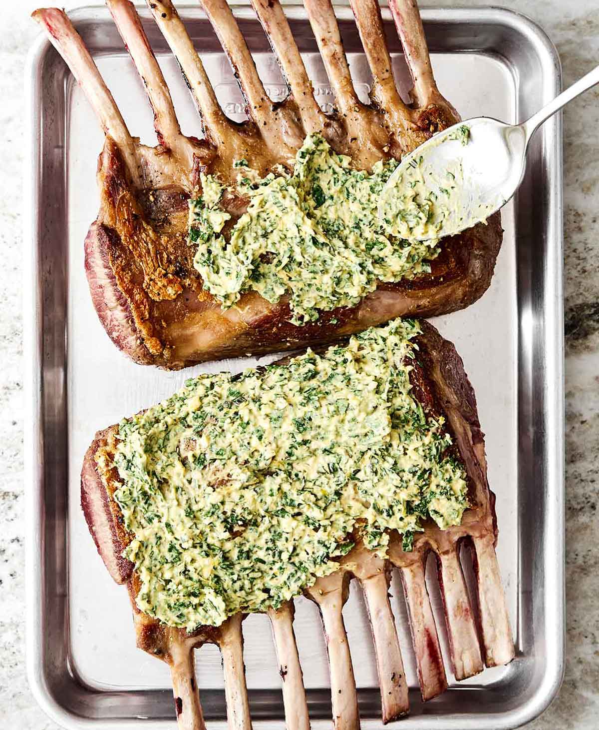 This rack of lamb with a Dijon herb crust will certainly shine at any holiday dinner. Plus, it's a lot easier to make than it looks! Step four of rack of lamb: spread herb butter on top.