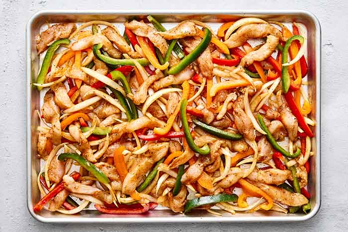 Step three of sheet pan chicken fajitas: bake in oven.