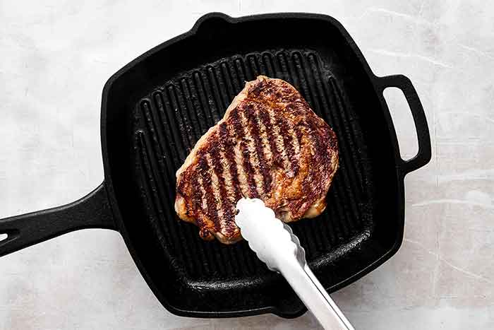 Grilling steak on a grill pan.
